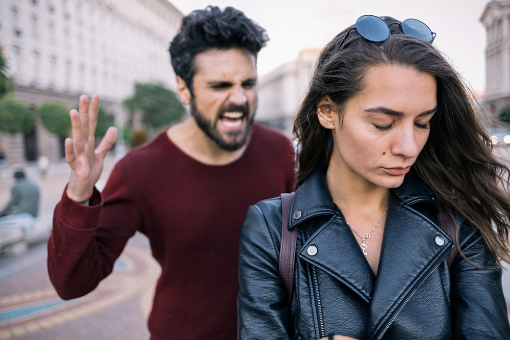 Angry Man Shouting as Woman Looks Away